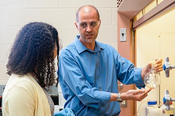 professor with student in chemistry lab